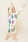 Child wearing a colorful onesie with abstract designs on a plain background