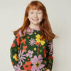 Child wearing Mon Coeur Wildflower Ruffle Long Sleeve T-Shirt in organic and recycled cotton blend
