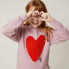 Child wearing Mon Coeur Heartfelt Sweatshirt, a sustainable kids' sweatshirt with heart detail