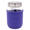 Glass jar with purple silicone sleeve and silver lid on a white background
