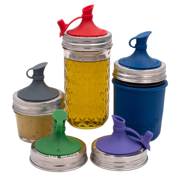 Set of glass jars with colorful lids on a white background. Transform your Mason jars with the Silicone Oil Cruet Pour Lid at Clozist. Enjoy mess-free, non-toxic pouring for oils and dressings. Durable, dishwasher safe, and eco-friendly. The perfect sustainable gift for an organized, plastic-free kitchen!