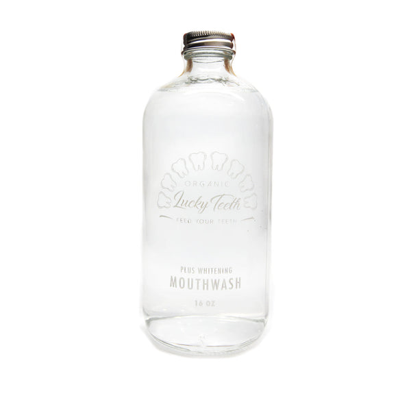 Clear mouthwash bottle with silver cap on a white background