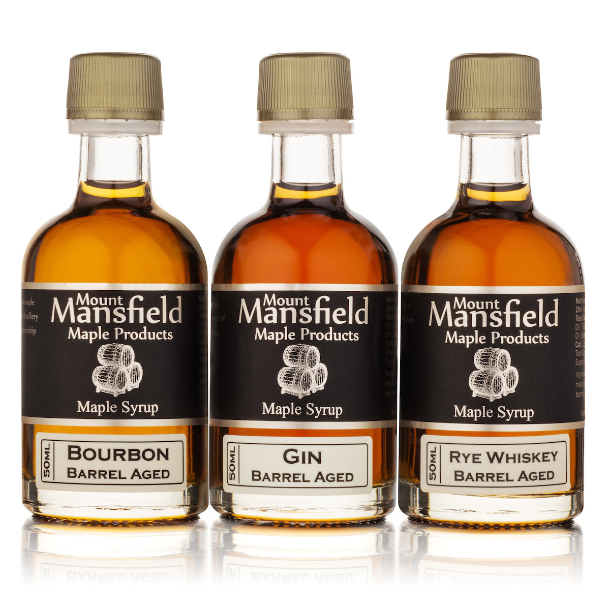 Three bottles of Barrel Aged Vermont Maple Syrup Sampler labeled Bourbon, Rye, and Single Malt