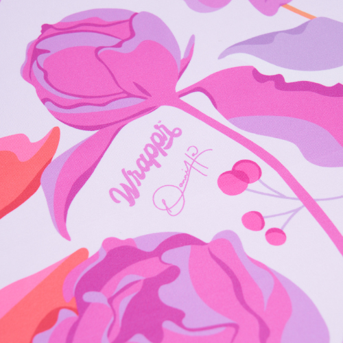 Decorative paper with pink and purple floral design and 'Wrapped' text on a light purple background