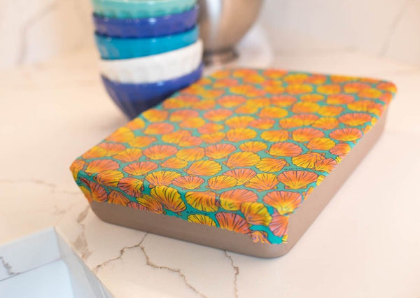 Colorful patterned box on a marble surface with a blurred background