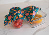 Glass containers with floral wrap on a marble surface