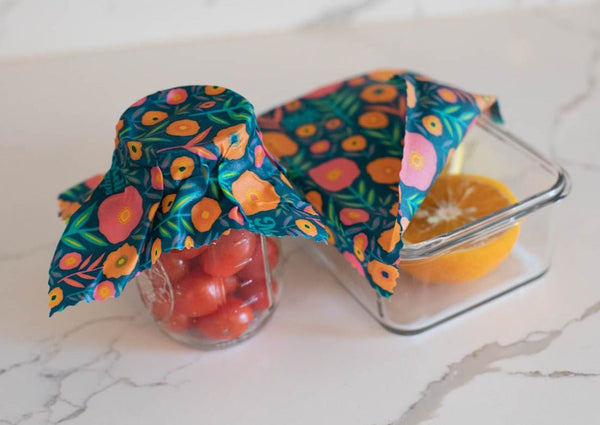 Glass containers with floral wrap on a marble surface