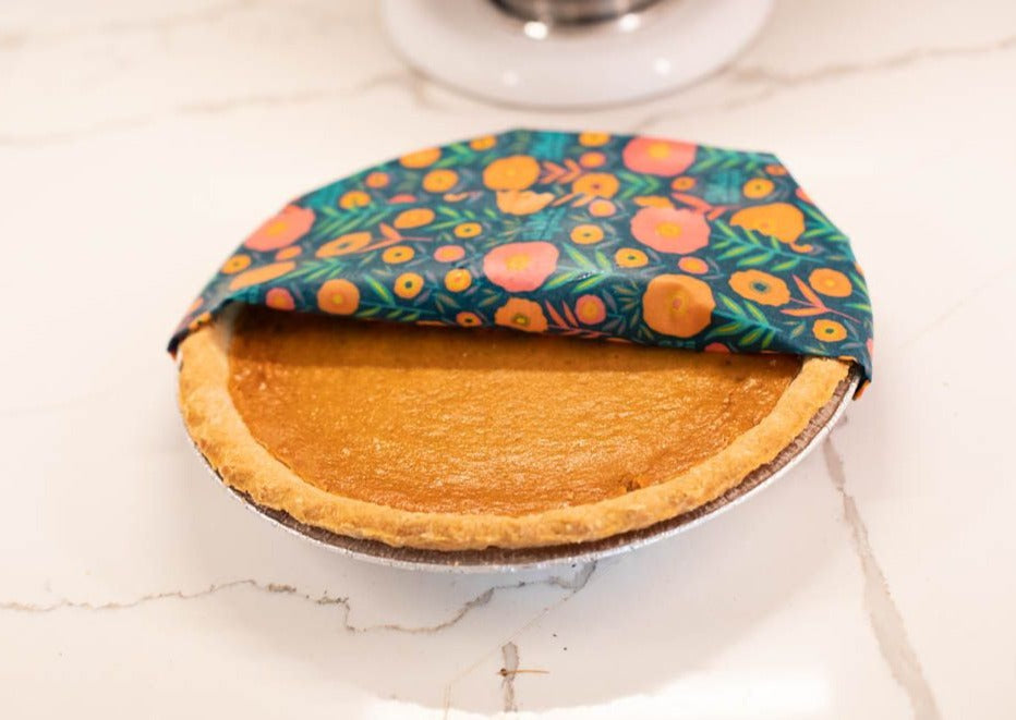 Pie with a floral wrap on a marble surface