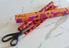 Meli Wraps packaging with orange and black design on a marble surface with scissors.