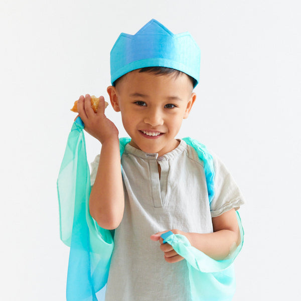 Child wearing a blue and green costume with a white background