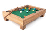 Miniature pool table with balls and a cue on a white background