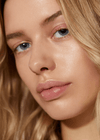 Model wearing Minori Beauty Lip Gloss in Dream shade — natural glossy lip finish