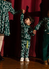 Child wearing the Mon Coeur Snowy Pine Jogger with matching sweatshirt, full outfit view