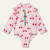 Pink children's swimsuit with cherry pattern on a white background