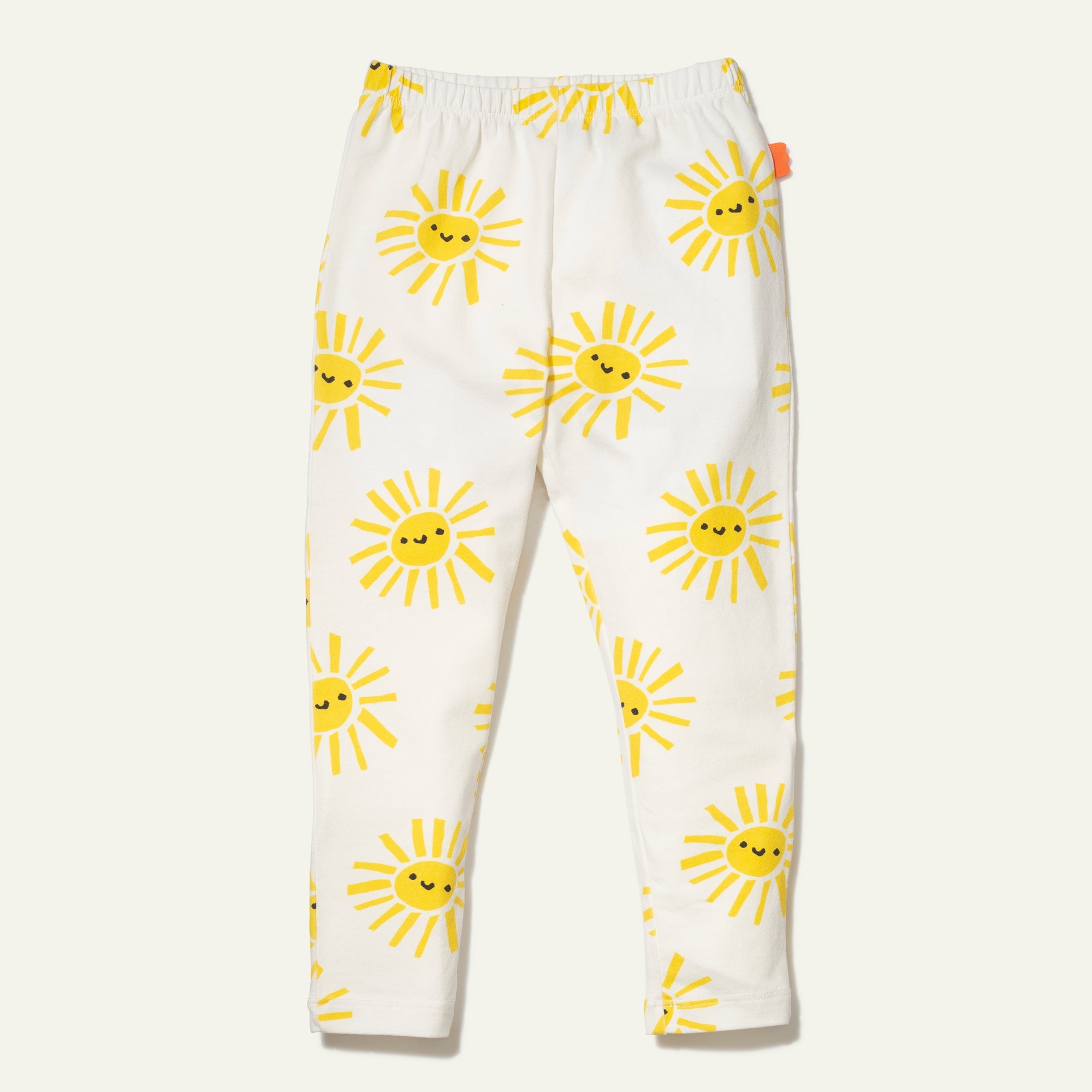 White pants with yellow sun patterns on a white background