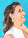 Fair Anita monstera stud earrings in brass-plated recycled metal, product flat lay