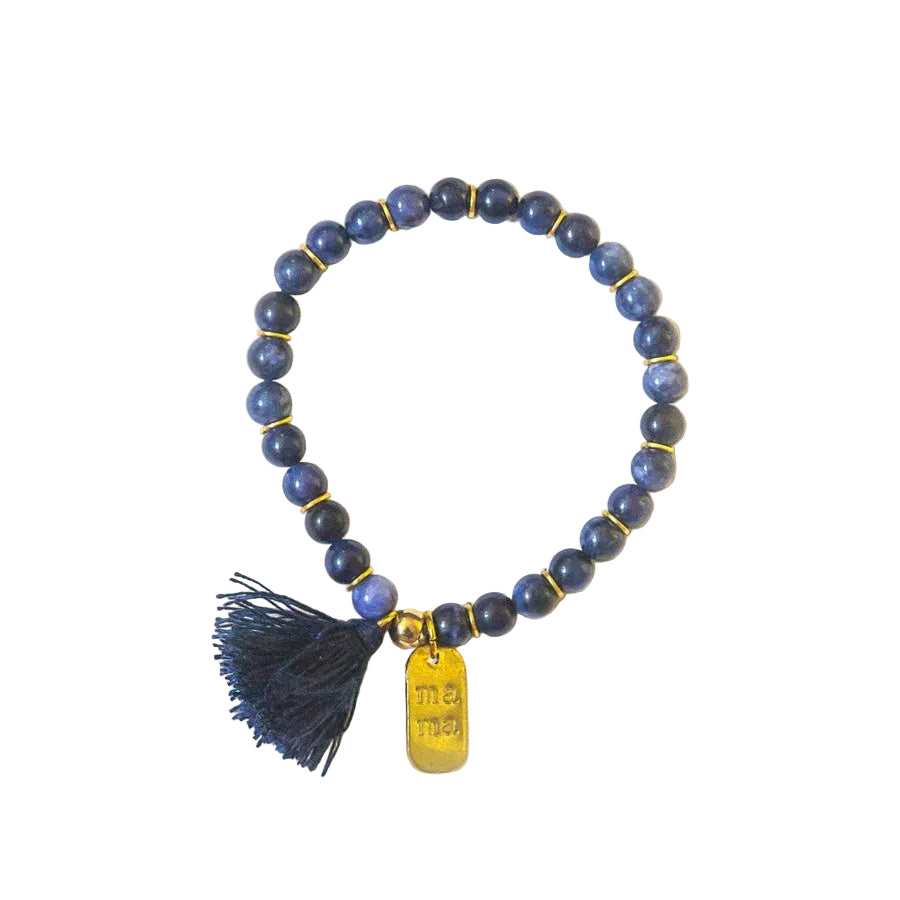 Close-up of Mother's Love Sodalite Bracelet showing hand-stamped mama charm and tassel detail