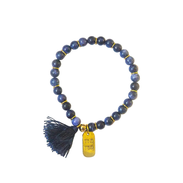 Close-up of Mother's Love Sodalite Bracelet showing hand-stamped mama charm and tassel detail
