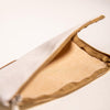 Close-up of a beige fabric pouch with a mesh interior on a light background