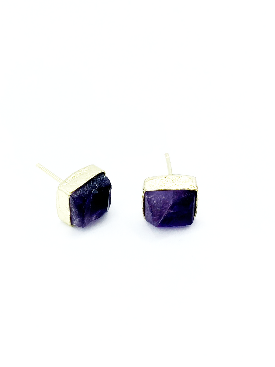 Close-up of uncut amethyst rectangle studs in recycled brass-plated brass setting, nickel-free