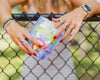 Person holding a package of 'Lovely' organic snacks with a blurred background