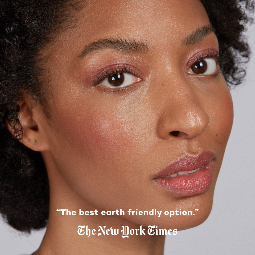 Close-up of a woman's face with a quote from The New York Times on a gray background