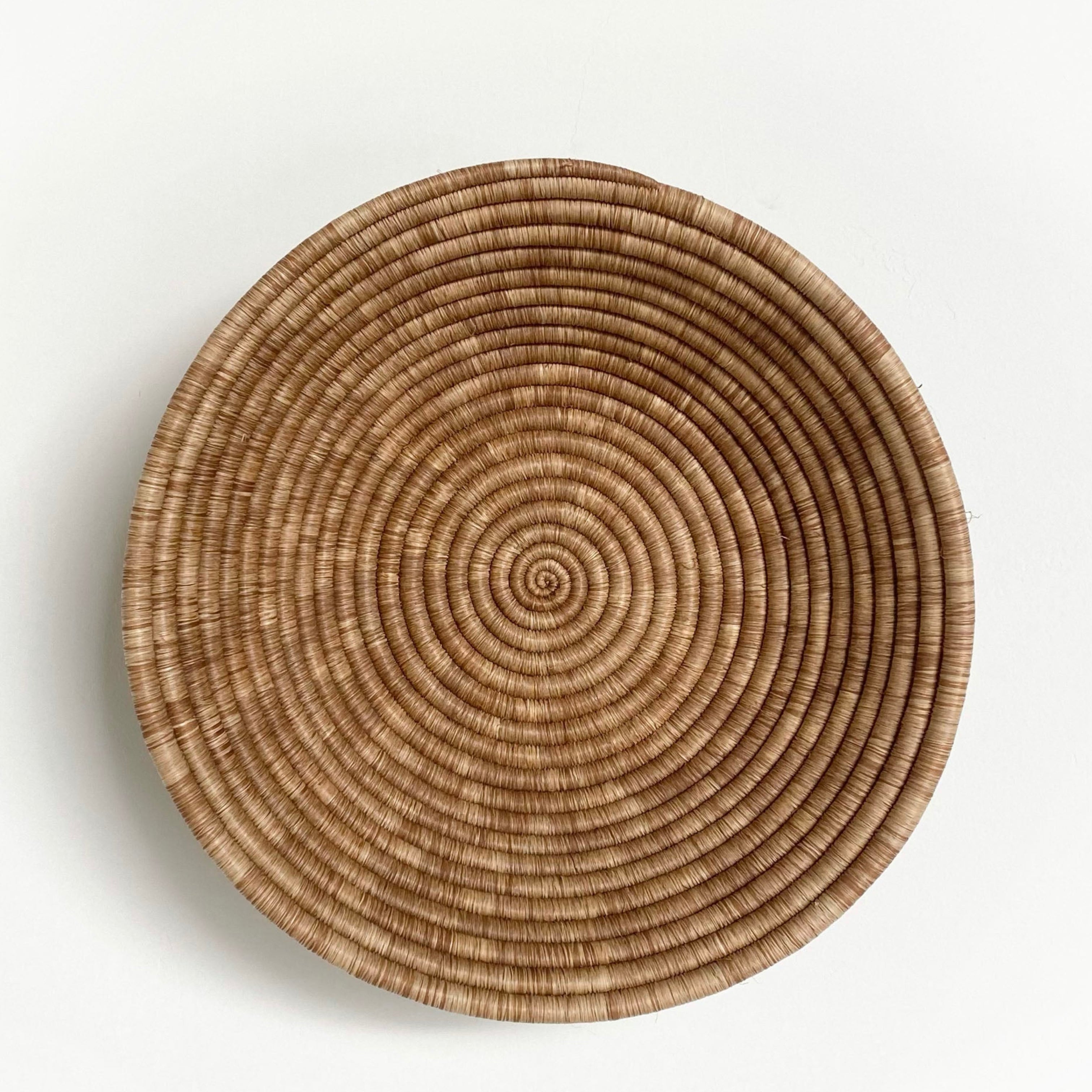 Large handmade natural sisal and sweetgrass woven wall plate basket by Plum+Sparrow, front view