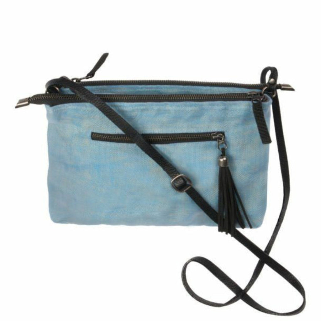 Front view of the Nearby Shoulder Bag showing zippered compartments and reflective net material
