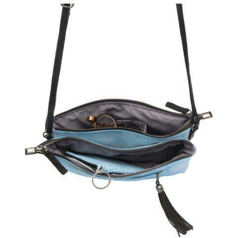 Blue handbag with black interior and tassels on a white background