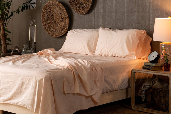 Neatly made bed with white bedding in a bedroom setting.