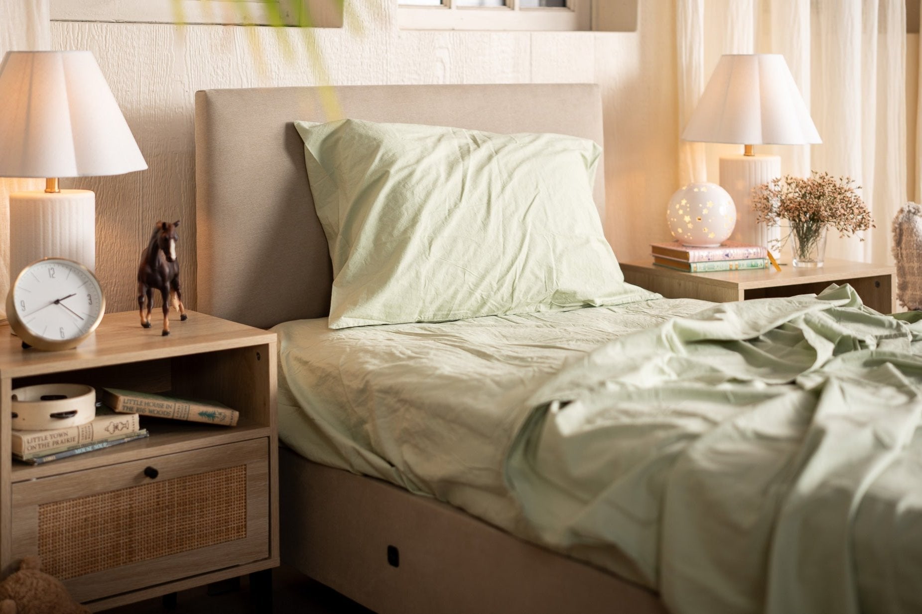 Bedroom with a bed, nightstands, and lamps in a cozy setting.