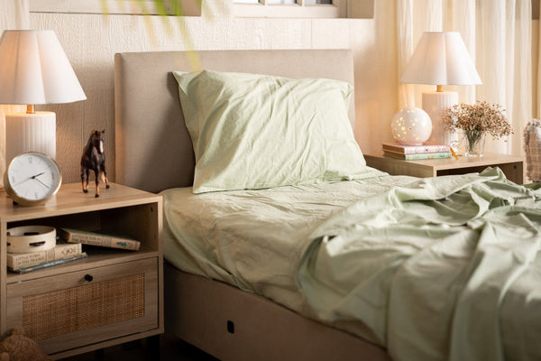Bedroom with a bed, nightstands, and lamps in a cozy setting.
