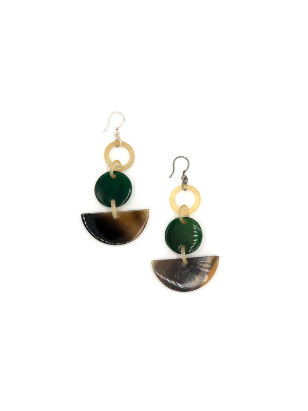 Detail view of handmade horn earrings showing natural texture and warm tones