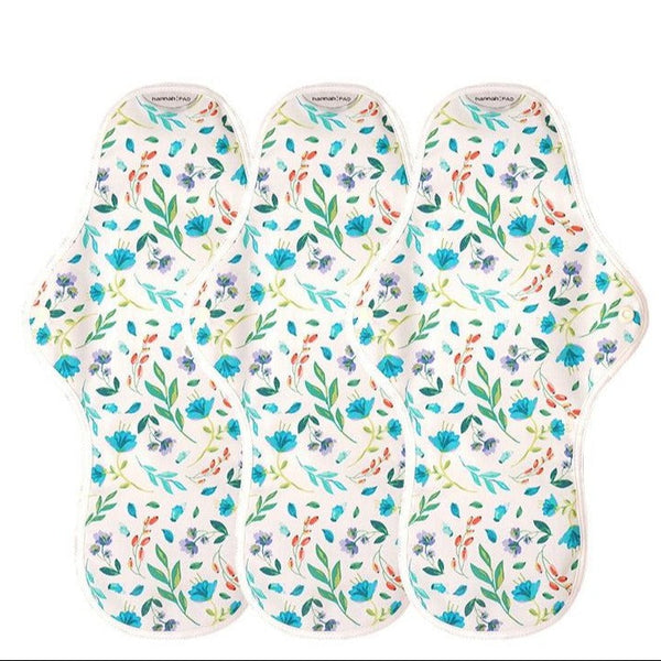 Three floral-patterned pads on a white background