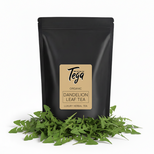 Black tea packaging with Tega label and dandelion leaves on a white background