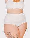 White high-waisted underwear worn by a person on a light gray background