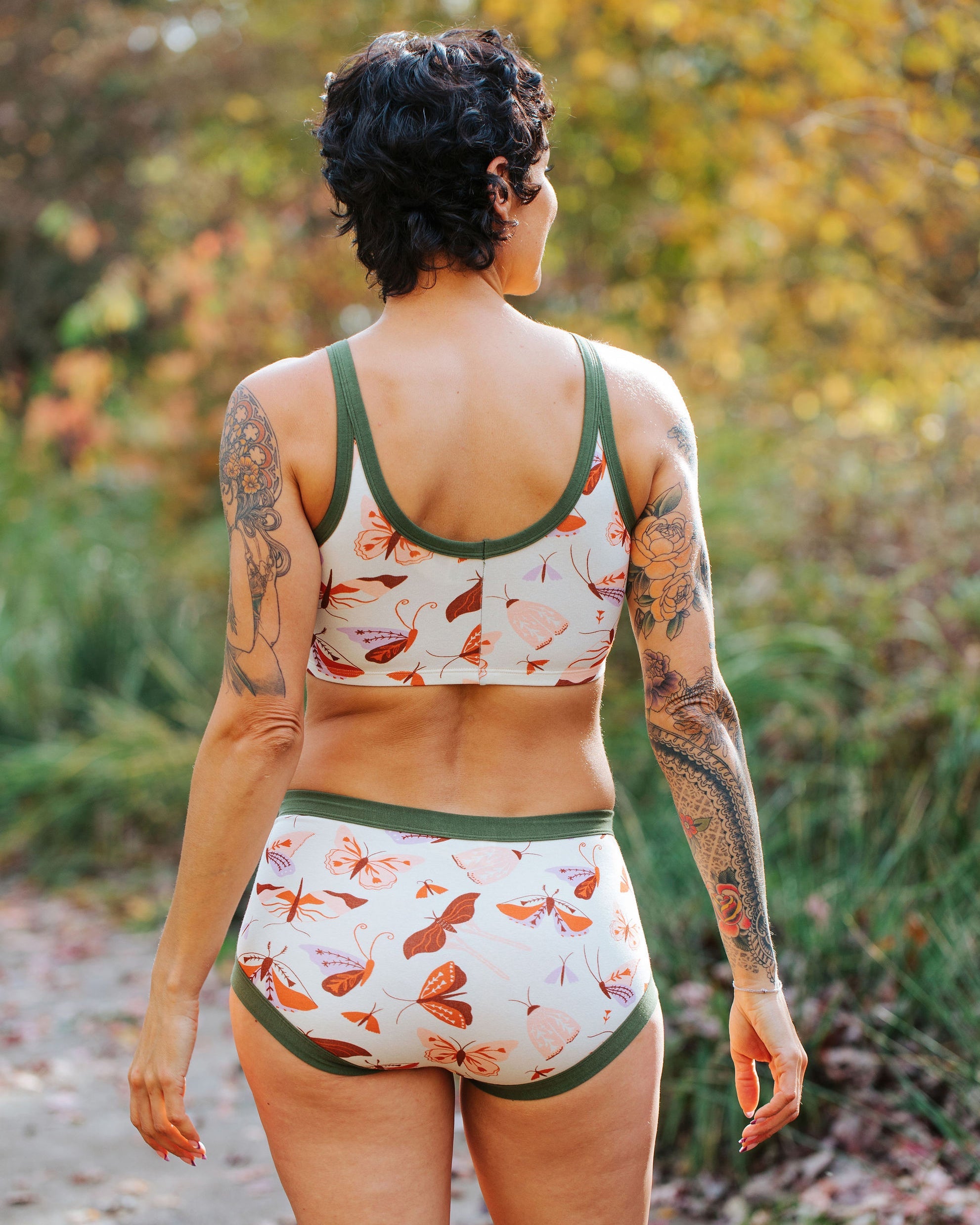 Person wearing a floral-patterned bikini set in a natural setting