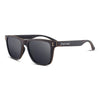 Joycoast Wayfinder Ebony wooden sunglasses with polarized lenses on a flat surface