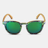 Sunglasses with green lenses and colorful frame on a light gray background