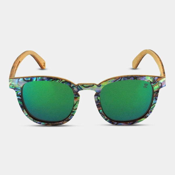 Sunglasses with green lenses and colorful frame on a light gray background