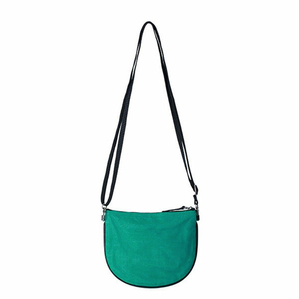 Green crossbody bag with a black strap on a white background
