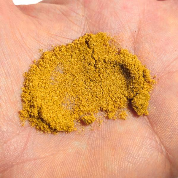 Yellow powder on a person's palm