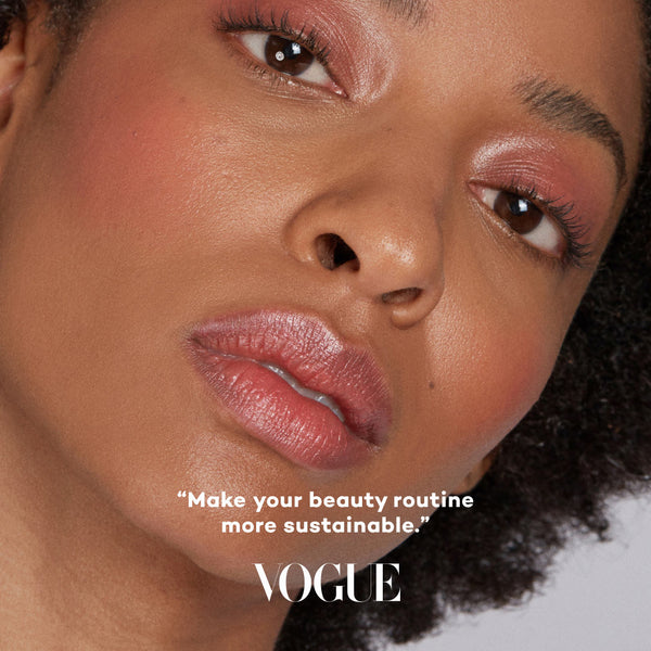 Close-up of a woman's face with makeup, featuring the Vogue logo and text.