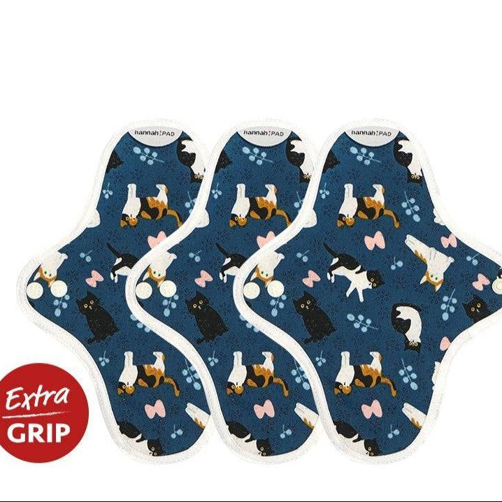 Hannah reusable pantyliner in classy cat blue organic cotton print, shown folded with snap closure