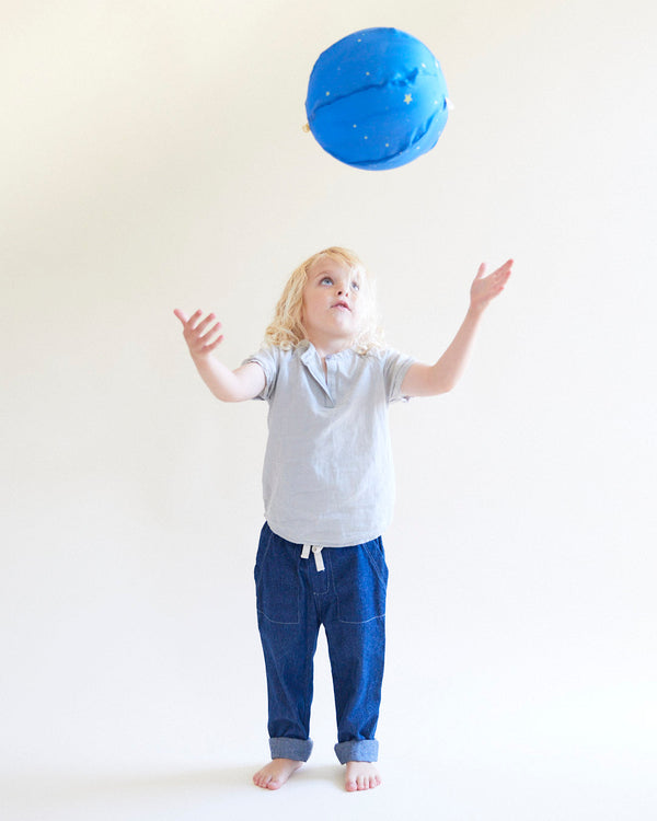 Child playing outdoors with a Sarah's Silks Star Balloon Ball, tossing the soft silk-covered play ball