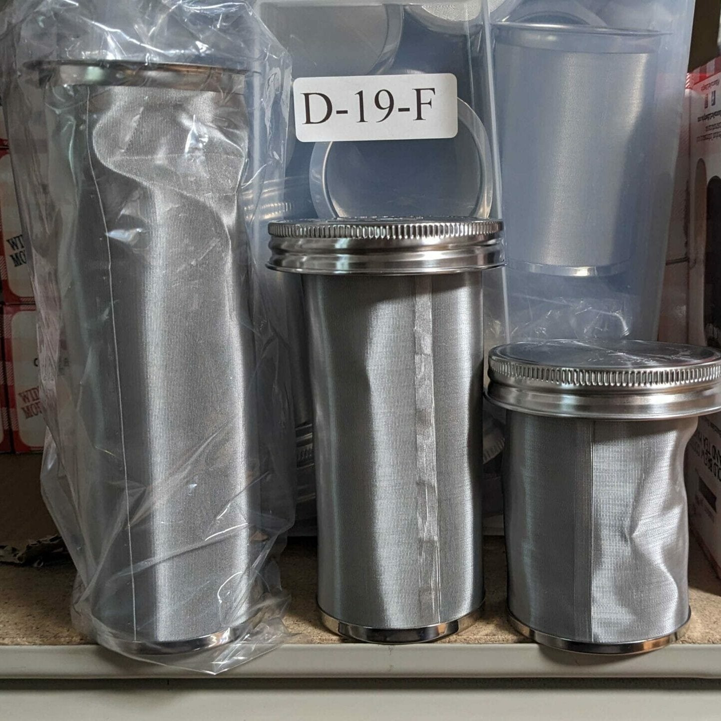 Metal filters with a label 'D-19-F' on a clear plastic bag.