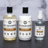 A set of three pet care products from Rustic Strength including a shampoo, conditioner, and deodorizing spray, each in labeled bottles.
