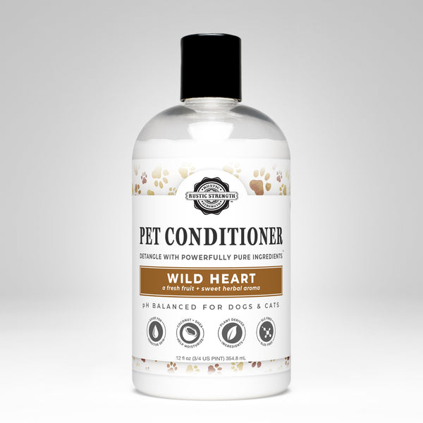 A bottle of Rustic Strength Pet Conditioner with the label 'Wild Heart'. The bottle is white with a label that has brown and black text and an image of a dog and a cat, indicating that it is suitable for both dogs and cats.