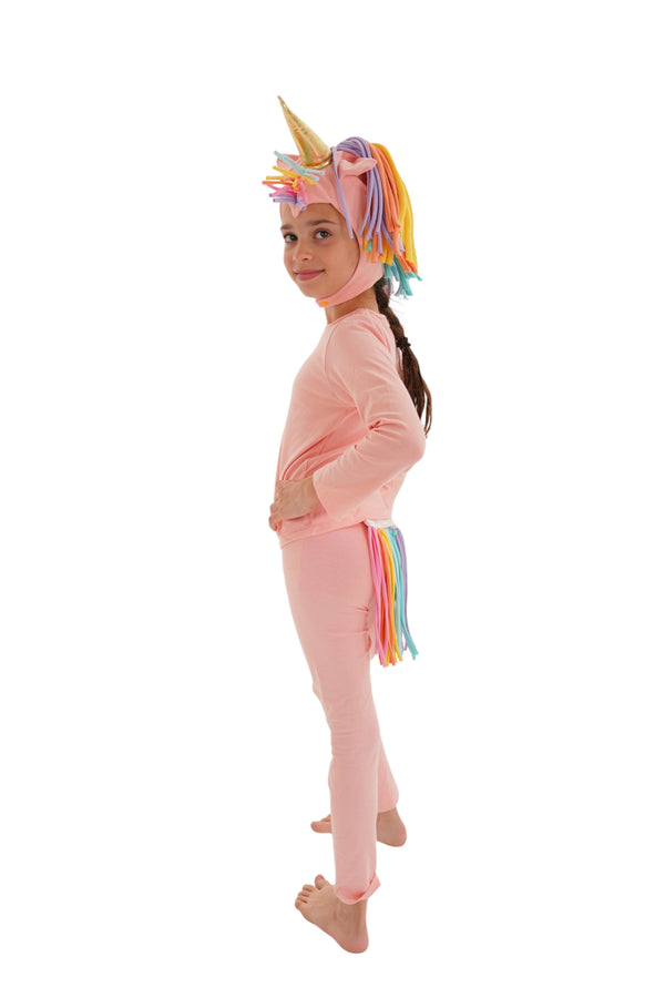 Child wearing a pink unicorn onesie with a colorful horn on a white background