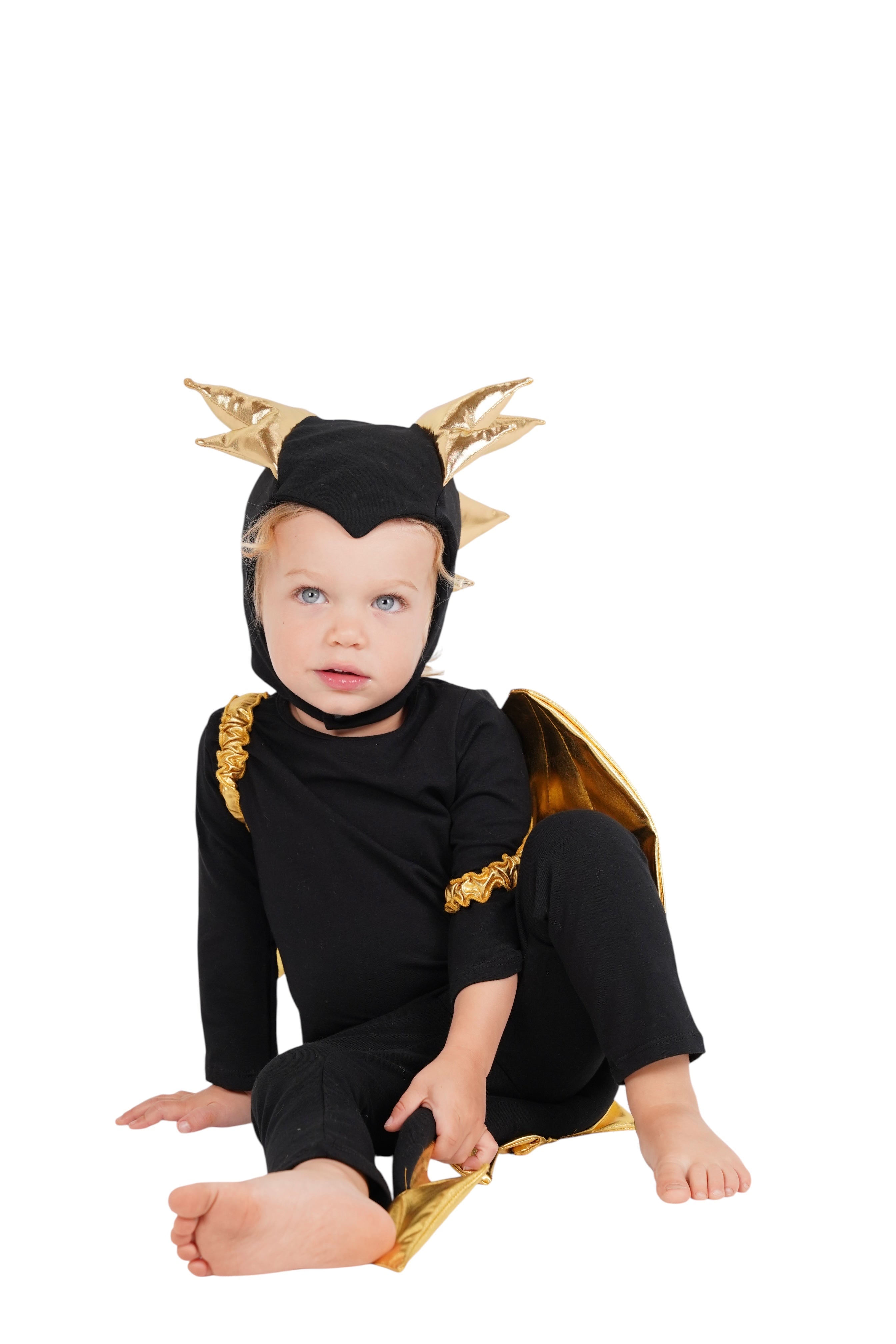 Child wearing a black and gold dragon costume on a white background
